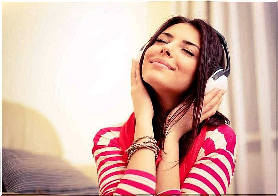 A woman is listening to music.